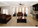 Cozy living room with a ceiling fan, curtains, and a fireplace with a mounted television at 4594 Marching Ln, Fairburn, GA 30213