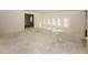 Bright living room featuring neutral walls, multiple windows for ample natural light and an open-concept floor plan at 4594 Marching Ln, Fairburn, GA 30213