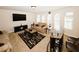 Comfortable living room with a large television, modern furniture, and a bar area at 4594 Marching Ln, Fairburn, GA 30213