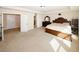 Large primary bedroom featuring a king bed, dark wood furniture, and neutral paint at 4594 Marching Ln, Fairburn, GA 30213