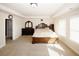Spacious primary bedroom featuring a trey ceiling, carpet floors, and natural lighting at 4594 Marching Ln, Fairburn, GA 30213