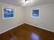 Bright bedroom featuring hardwood floors, two windows, and neutral paint at 728 Birchwood Sw Ln, Marietta, GA 30060