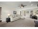 Spacious living room featuring a comfortable sectional sofa, ceiling fan and plenty of natural light at 2078 Dayron Cir, Marietta, GA 30062