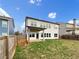 Spacious backyard featuring a covered patio, privacy fence, and ample green space, perfect for outdoor living at 507 N Gwinnett St, Buford, GA 30518