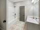 Bathroom featuring a vanity, and shower and bathtub combo with tile flooring at 507 N Gwinnett St, Buford, GA 30518