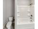Bathroom with a toilet and a shower/tub combo with built in shelving at 507 N Gwinnett St, Buford, GA 30518