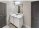 Charming bathroom features a vanity with gray cabinets, and decorative lighting at 507 N Gwinnett St, Buford, GA 30518
