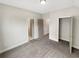 Spacious bedroom with plush carpet and multiple entryways provides comfort and versatility at 507 N Gwinnett St, Buford, GA 30518