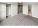 Bedroom with open closet, neutral carpet, and ample natural light at 507 N Gwinnett St, Buford, GA 30518