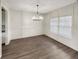 Dining room featuring wainscotting, chandelier, and a window allowing for natural light at 507 N Gwinnett St, Buford, GA 30518