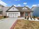 Charming single-Gathering home with a brick and white facade, and a two-car garage at 507 N Gwinnett St, Buford, GA 30518
