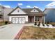 Charming single-Gathering home with a brick and white facade, and a two-car garage at 507 N Gwinnett St, Buford, GA 30518