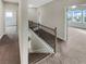 Hallway with carpeted floors, neutral walls, and views into bedrooms at 507 N Gwinnett St, Buford, GA 30518