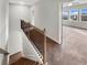 Upper hallway with carpeted floors, and views into bedrooms at 507 N Gwinnett St, Buford, GA 30518