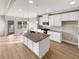 Open kitchen featuring a large island, granite countertops, and modern appliances at 507 N Gwinnett St, Buford, GA 30518