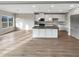Open concept kitchen with white cabinets, granite countertops, island, and stainless steel appliances at 507 N Gwinnett St, Buford, GA 30518