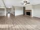 Open living space with fireplace and wood flooring, seamlessly connecting to the kitchen at 507 N Gwinnett St, Buford, GA 30518