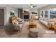 Bright, staged living room with neutral tones, a brick fireplace, and ample natural light at 507 N Gwinnett St, Buford, GA 30518