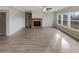 Spacious living room with fireplace, hardwood floors and large windows overlooking the backyard at 507 N Gwinnett St, Buford, GA 30518