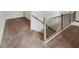Carpeted staircase with metal balusters and wooden handrail at 507 N Gwinnett St, Buford, GA 30518