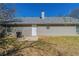 Back of the home showing the siding, a door to the backyard, and a small patio at 11139 Silver Aspen Ct, Hampton, GA 30228