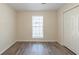 A bedroom with hardwood floors, a window, and a closet at 11139 Silver Aspen Ct, Hampton, GA 30228