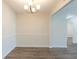 Dining room features hardwood floors, chair railing, chandelier, and open floor plan at 11139 Silver Aspen Ct, Hampton, GA 30228