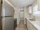 The kitchen features stainless steel appliances, white cabinets, and light countertops at 11139 Silver Aspen Ct, Hampton, GA 30228