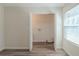 An open laundry room with a window and wooden floors at 11139 Silver Aspen Ct, Hampton, GA 30228