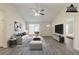 This staged living room boasts hardwood floors, fireplace, ceiling fan, lots of sunlight, and an open floor plan at 11139 Silver Aspen Ct, Hampton, GA 30228