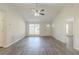The bright, open living room features hardwood floors, tall ceilings, and a lot of natural light at 11139 Silver Aspen Ct, Hampton, GA 30228