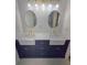 Bathroom with double sinks, modern fixtures, and a navy blue vanity at 2308 Baywood Se Dr, Atlanta, GA 30315