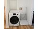 Laundry area with a modern white washer and hardwood floors at 2308 Baywood Se Dr, Atlanta, GA 30315