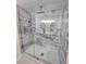 Luxurious shower featuring marble tiling, glass doors, and gold fixtures at 2308 Baywood Se Dr, Atlanta, GA 30315