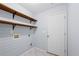 A laundry room with wood shelving at 3442 Summit Creek Ln, Loganville, GA 30052