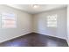 An empty bedroom features hardwood floors and natural light from two windows at 4051 Ester Sw Dr, Atlanta, GA 30331