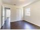 An empty bedroom features hardwood floors, a window, and closet with double doors at 4051 Ester Sw Dr, Atlanta, GA 30331
