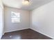 Serene bedroom with dark wood-look floors, fresh paint, and a window providing natural light and a view of the neighborhood at 4051 Ester Sw Dr, Atlanta, GA 30331