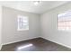 Bright bedroom with hardwood floors and natural light through two windows at 4051 Ester Sw Dr, Atlanta, GA 30331