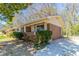 Side view of a single-story brick home featuring a covered front porch and a concrete driveway leading to the backyard at 4051 Ester Sw Dr, Atlanta, GA 30331