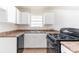 Functional kitchen with stainless steel sink, white cabinetry, and updated appliances for convenient meal preparation at 4051 Ester Sw Dr, Atlanta, GA 30331