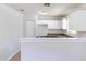 Clean kitchenette with white cabinets, a breakfast bar, and updated appliances for casual dining and convenience at 4051 Ester Sw Dr, Atlanta, GA 30331