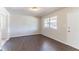 Sunlit living room features wood-look flooring, fresh paint, and a view of the front yard through a large window at 4051 Ester Sw Dr, Atlanta, GA 30331