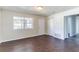 Open-concept living area with wood-look floors, freshly painted walls, and an exterior door for easy access to the front at 4051 Ester Sw Dr, Atlanta, GA 30331