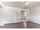 Bright living room with dark wood-look floors, fresh white paint and an open doorway leading to the kitchen area at 4051 Ester Sw Dr, Atlanta, GA 30331