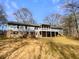 Expansive backyard with a deck, screened porch, and mature trees provides a private outdoor retreat at 8014 Bells Ferry Rd, Canton, GA 30114