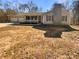Charming single-story home with a stone chimney, inviting front porch, and an attached three-car garage at 8014 Bells Ferry Rd, Canton, GA 30114