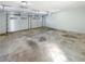 Spacious three-car garage featuring white doors and concrete flooring provides ample space for parking and storage at 8014 Bells Ferry Rd, Canton, GA 30114