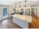 Modern kitchen boasts granite countertops, stainless steel appliances, and an island with pendant lighting at 8014 Bells Ferry Rd, Canton, GA 30114