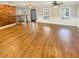 Spacious living room boasts gleaming hardwood floors, a decorative wood wall, and staircase to the upper level at 8014 Bells Ferry Rd, Canton, GA 30114